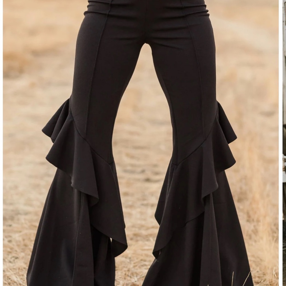 Bell bottomed style suede pants with ruffled flaps along side of legs